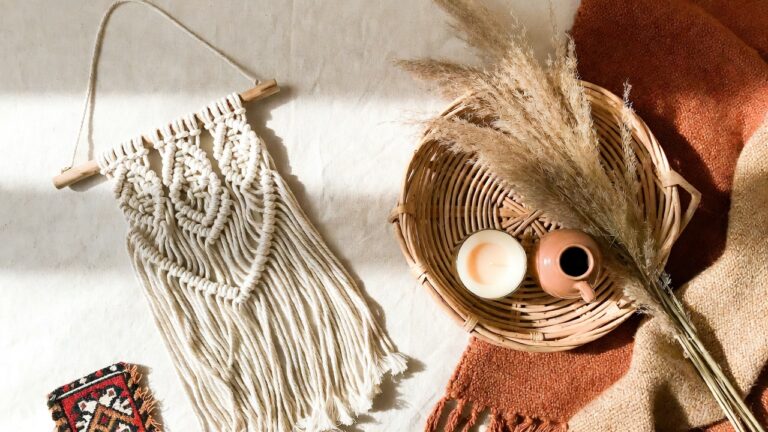 flatlay of bohemian home decor finds on amazon — macramé, rattan tray, pampas grass, warm earthy tones 2026