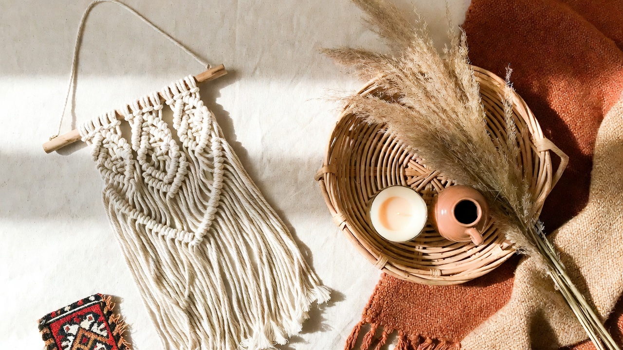 flatlay of bohemian home decor finds on amazon — macramé, rattan tray, pampas grass, warm earthy tones 2026