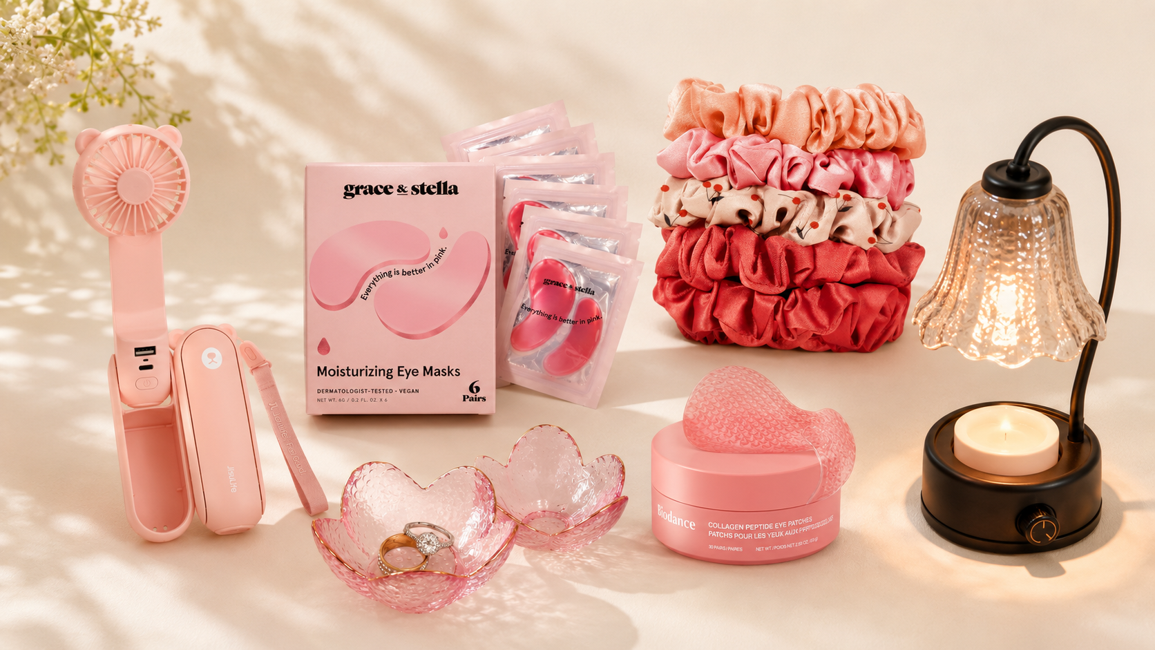 flatlay of gifts for her under $20 from amazon — eye masks, scrunchies, jewelry dish, candle warmer 2026