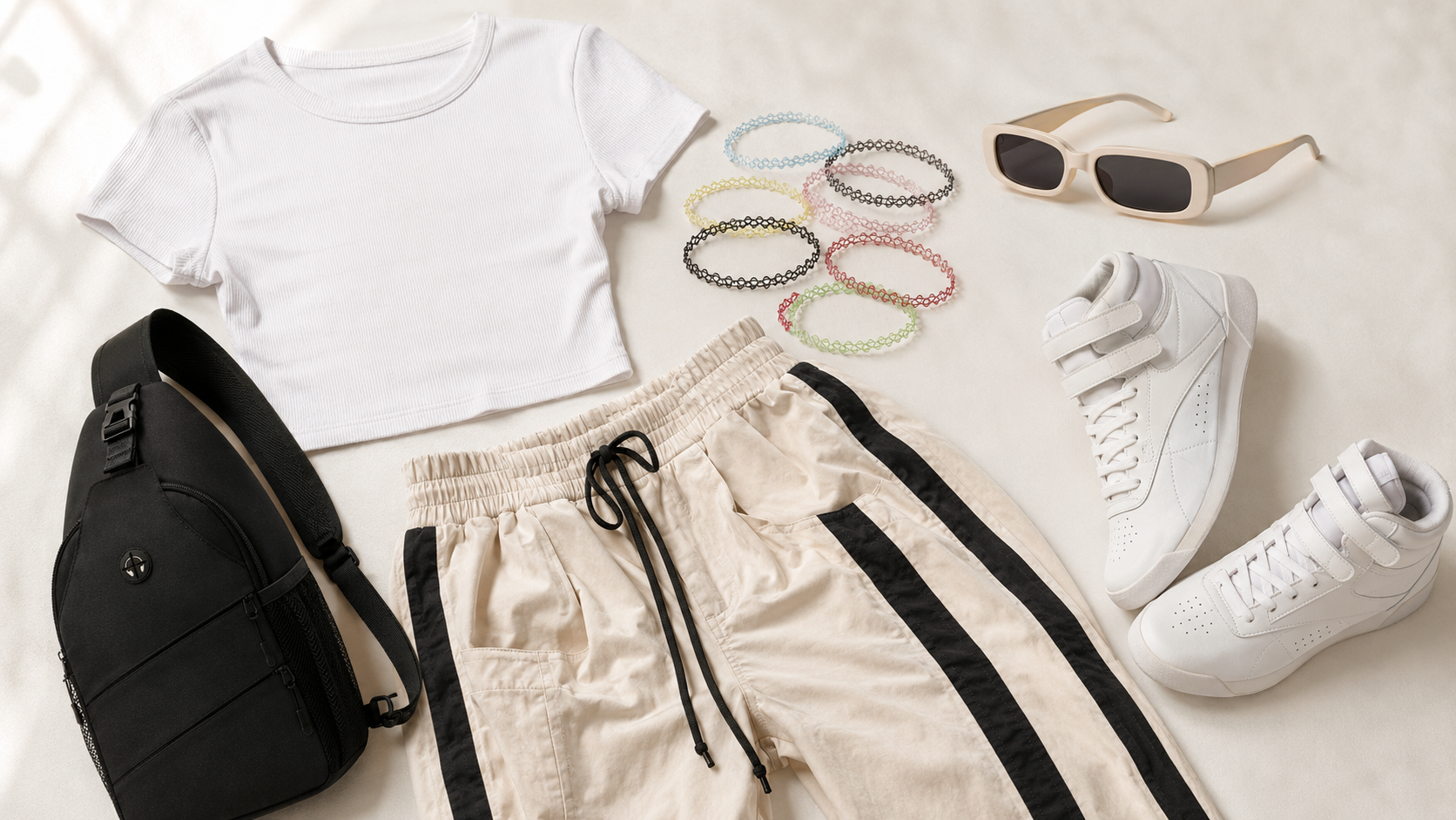 y2k amazon outfit flatlay — crop tee, track pants, choker, retro sunnies, reebok sneakers and sling bag 2026